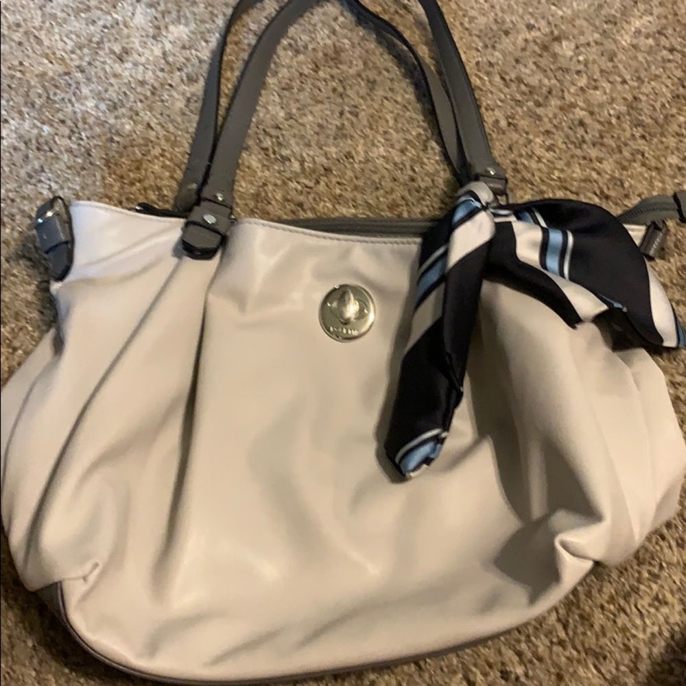 Gray purse with navy blue silk tie.